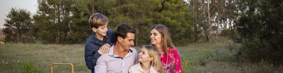 Family sitting in a field